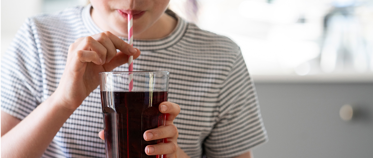 Person drinking a beverage through a straw