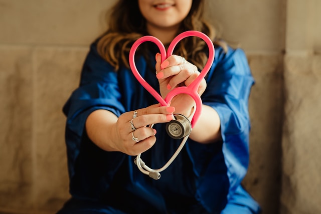 Person holding a heart shaped stethoscope