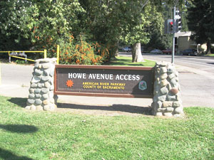 Sign for "Howe Avenue Access" to the American River Parkway in Sacramento County, California, with decorative stone columns.
