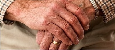 Close up of an elderly person's hands folding on top of eachother